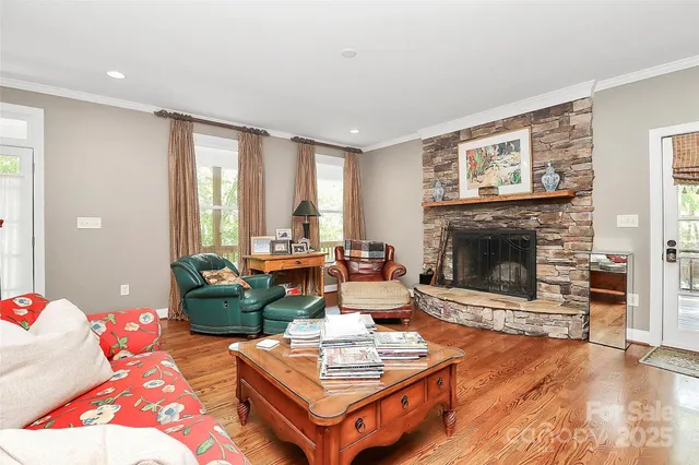 a living room with fireplace furniture and a large window