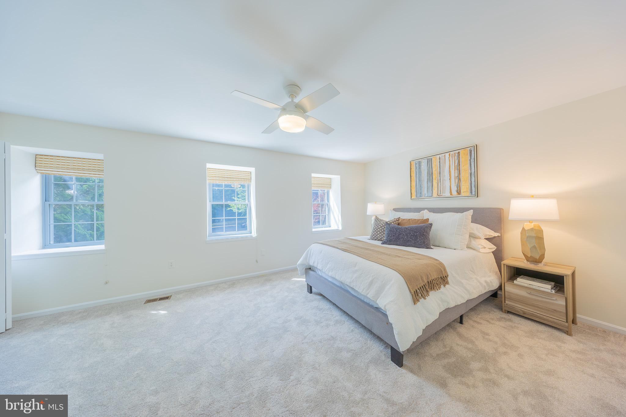 11714 Dry River Court Reston, VA 20191 - Photo 7 of 18 a spacious bedroom with a bed and a chandelier