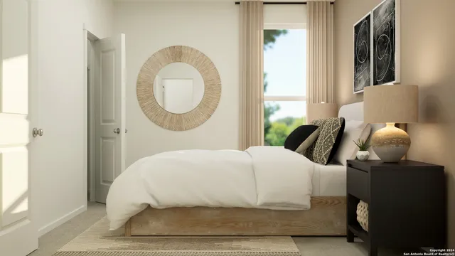 a bedroom with a bed and a large mirror