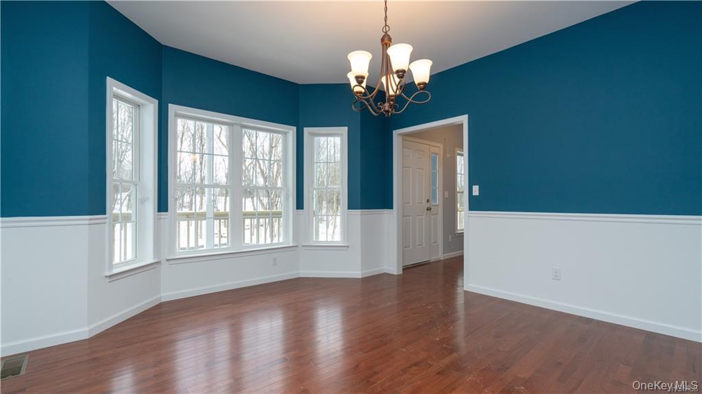 5 Harrier Ridge Drive Wallkill, NY 12589 - Photo 10 of 32 Unfurnished dining area featuring a chandelier and dark wood-style floors