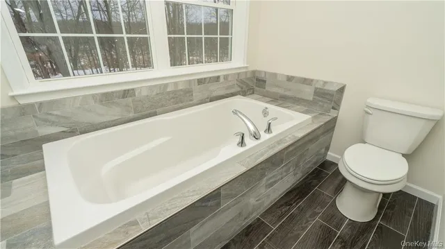 a bathroom with a granite countertop sink a mirror and shower