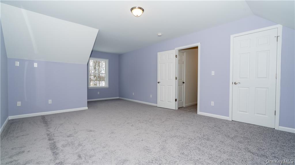 5 Harrier Ridge Drive Wallkill, NY 12589 - Photo 19 of 32 Bonus room featuring light colored carpet and vaulted ceiling