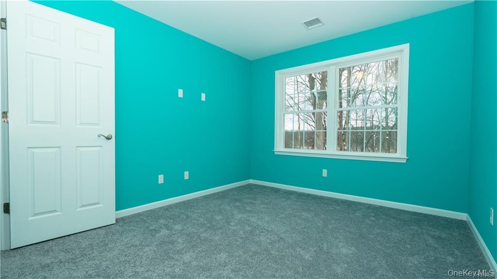 5 Harrier Ridge Drive Wallkill, NY 12589 - Photo 23 of 32 Unfurnished bedroom with baseboards and dark colored carpet