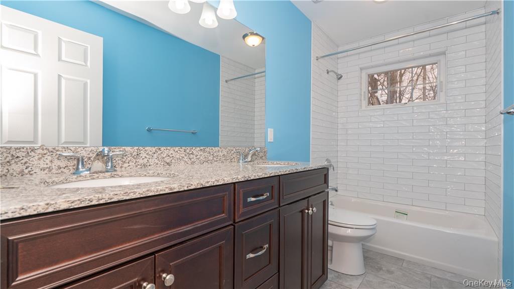 5 Harrier Ridge Drive Wallkill, NY 12589 - Photo 25 of 32 Full bath with shower / tub combination, double vanity, and light tile patterned flooring