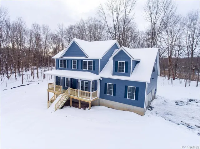 a view of a house with a yard covered in snow