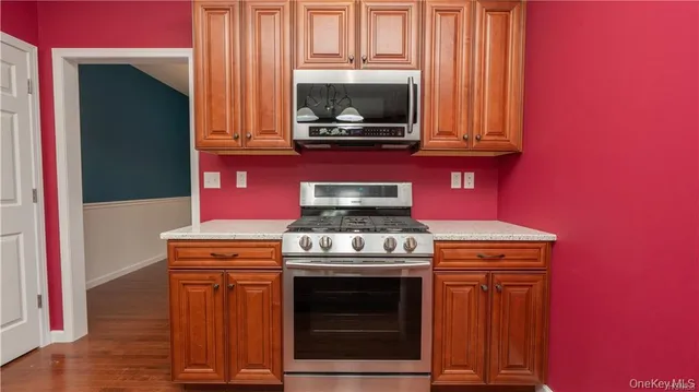a kitchen with stainless steel appliances a refrigerator and a stove