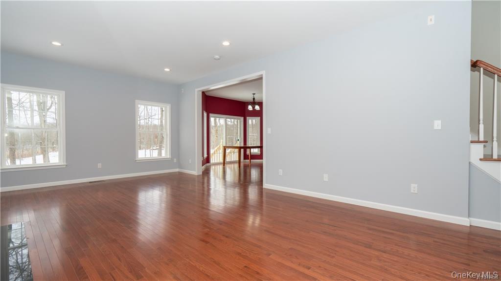 5 Harrier Ridge Drive Wallkill, NY 12589 - Photo 9 of 32 Empty room with dark wood-type flooring, a chandelier, recessed lighting, and stairway