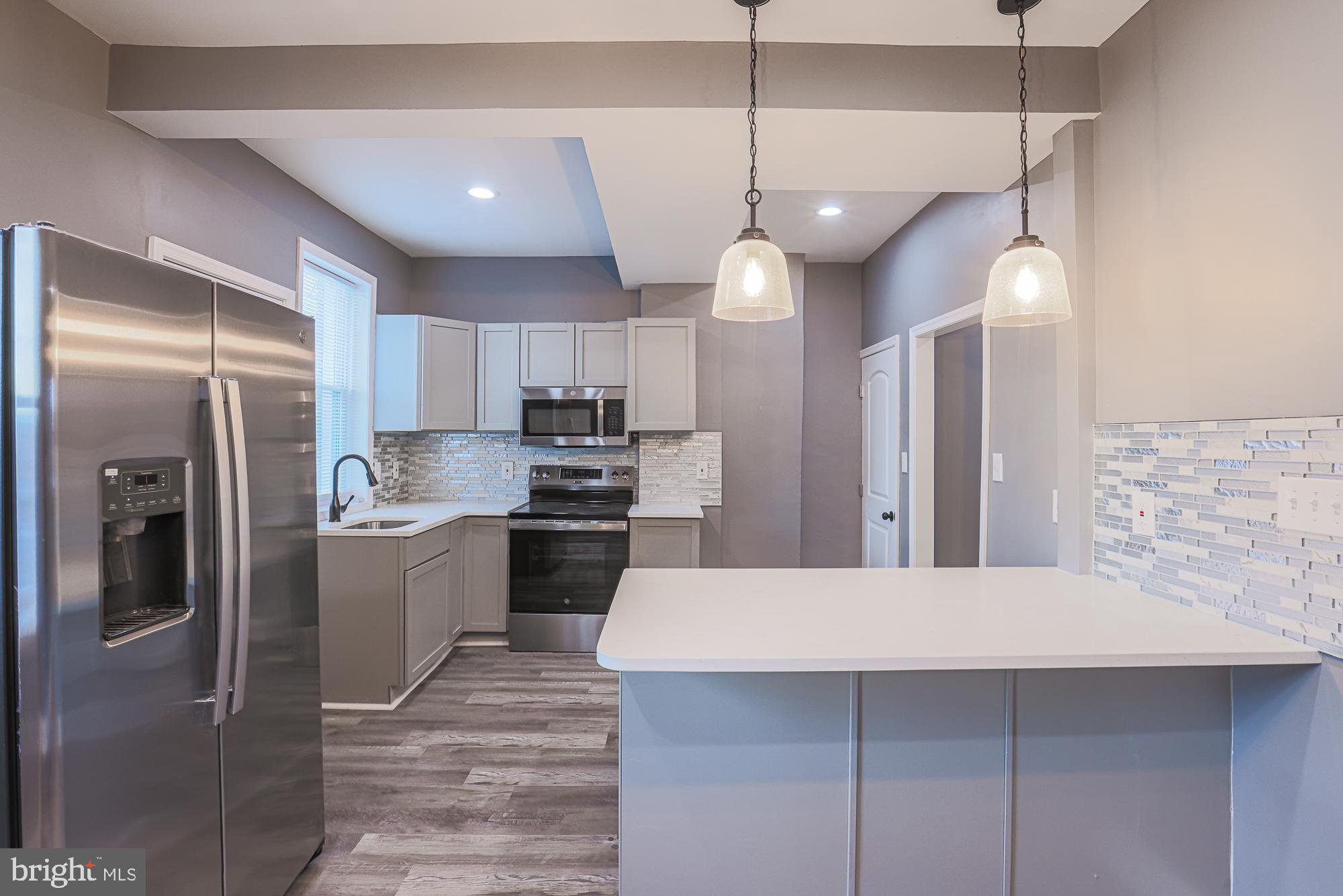 a kitchen with a refrigerator a sink and dishwasher