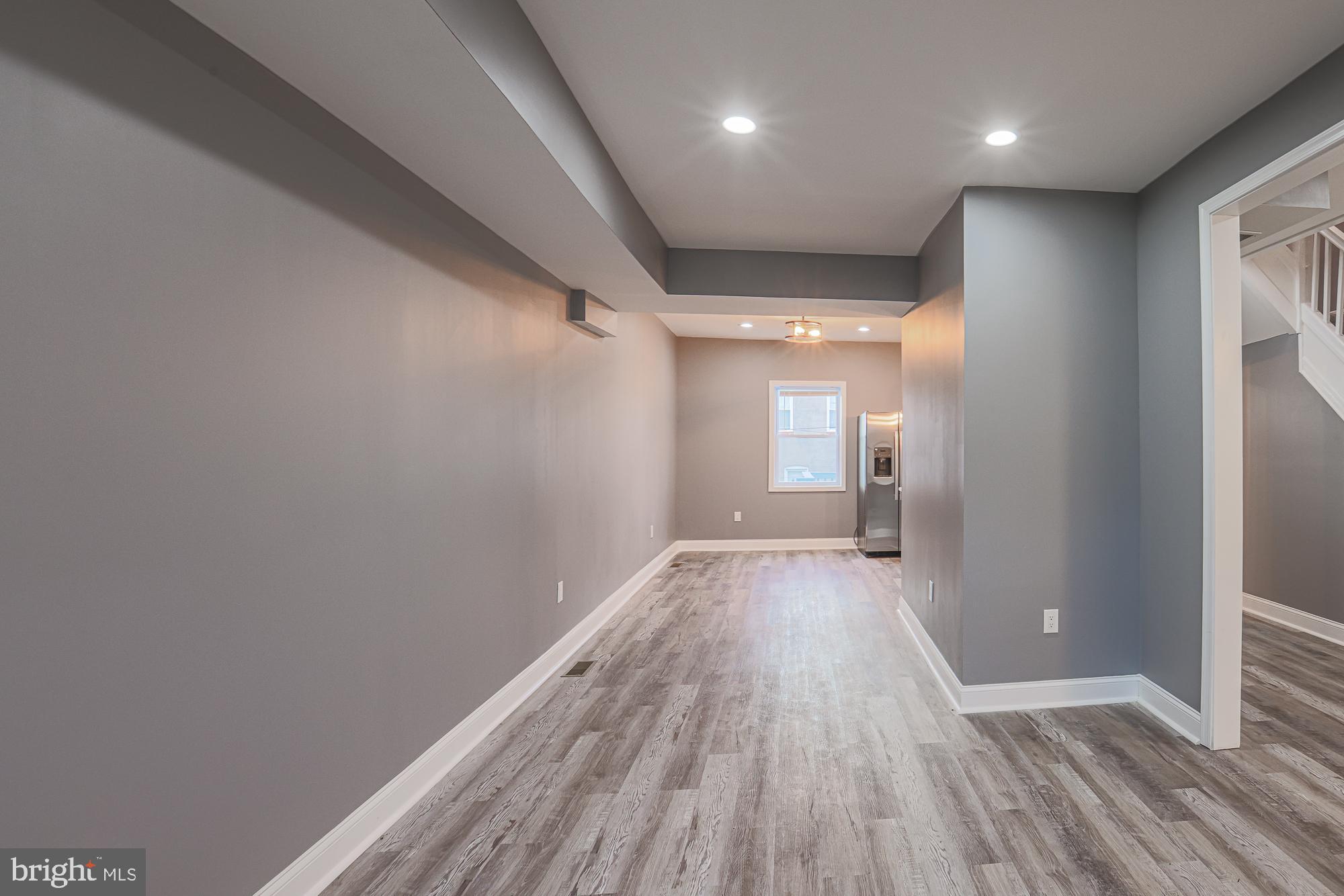3611 Belair Road Baltimore, MD 21213 - Photo 20 of 60 a view of a room with wooden floor and a window
