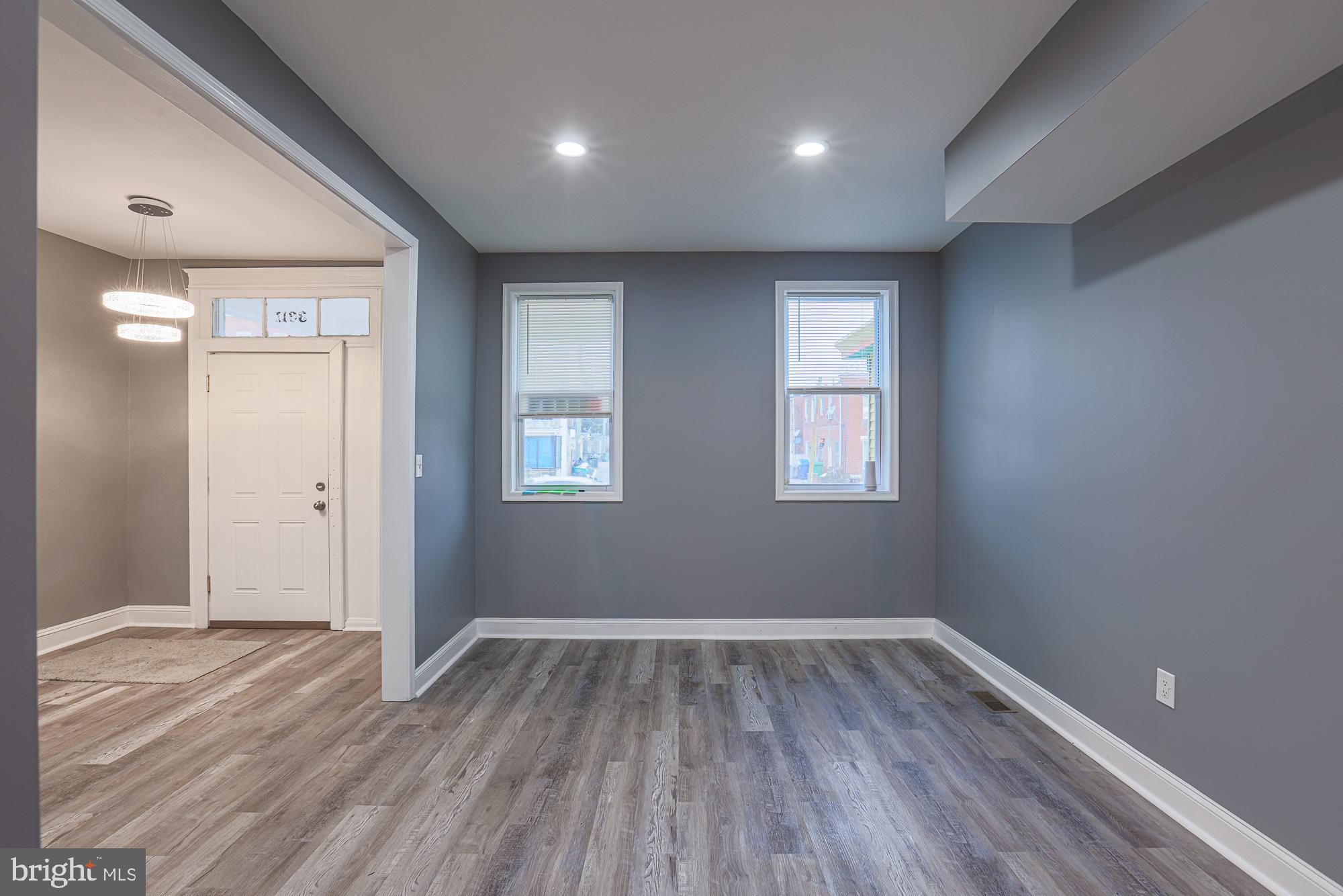 3611 Belair Road Baltimore, MD 21213 - Photo 23 of 60 a view of room with window and wooden floor