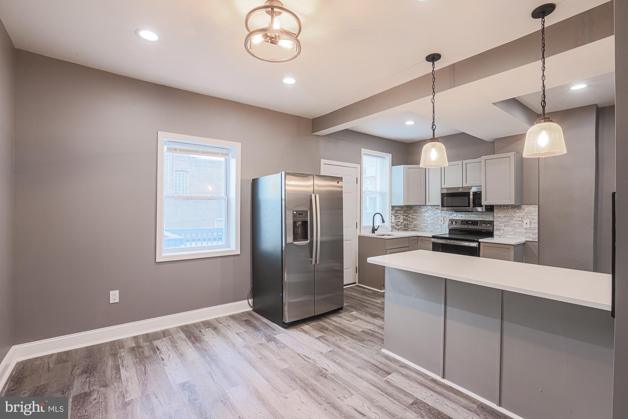 3611 Belair Road Baltimore, MD 21213 - Photo 24 of 60 a kitchen with stainless steel appliances granite countertop a refrigerator a sink and a stove