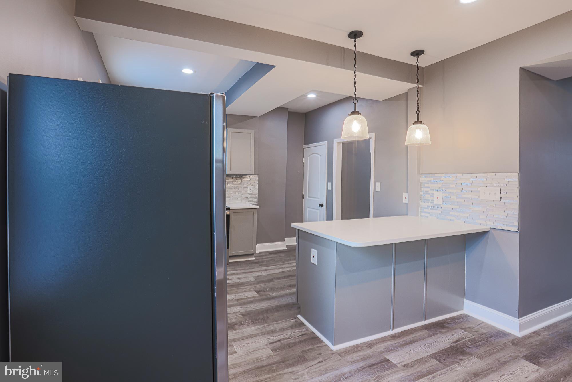 3611 Belair Road Baltimore, MD 21213 - Photo 27 of 60 a bathroom with a sink a vanity and a mirror