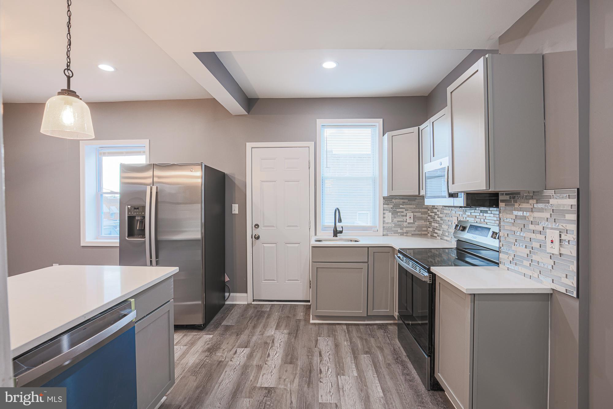 3611 Belair Road Baltimore, MD 21213 - Photo 32 of 60 a kitchen with a sink stove and refrigerator