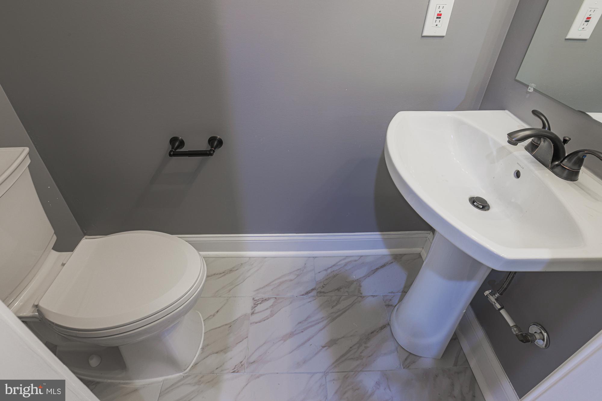 3611 Belair Road Baltimore, MD 21213 - Photo 35 of 60 a bathroom with a sink and a toilet