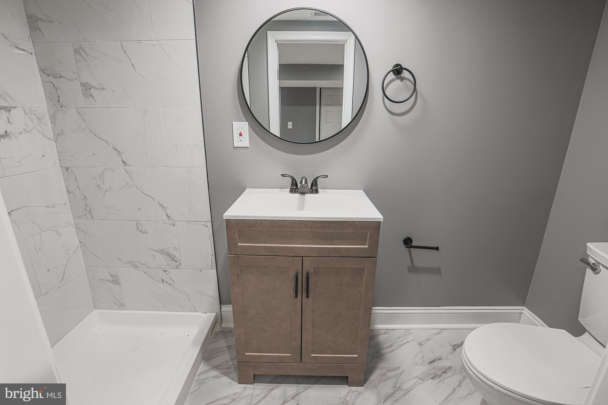 3611 Belair Road Baltimore, MD 21213 - Photo 38 of 60 a bathroom with a sink a toilet and a mirror