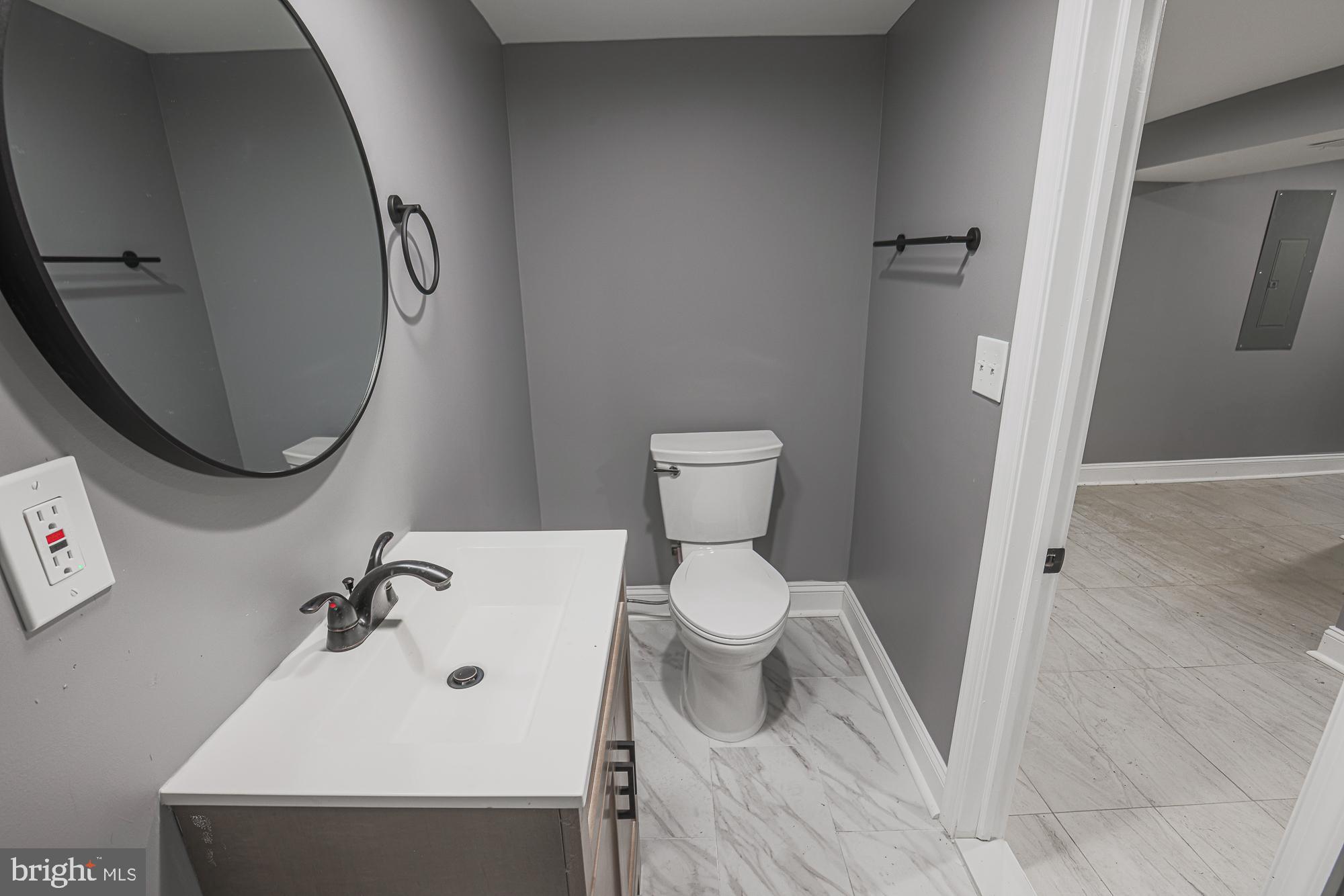 3611 Belair Road Baltimore, MD 21213 - Photo 40 of 60 a bathroom with a sink and a mirror