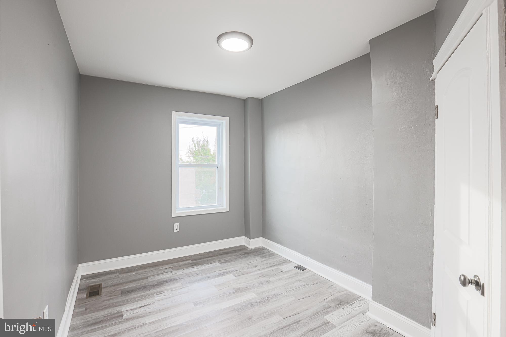 3611 Belair Road Baltimore, MD 21213 - Photo 43 of 60 a view of empty room with wooden floor and fan