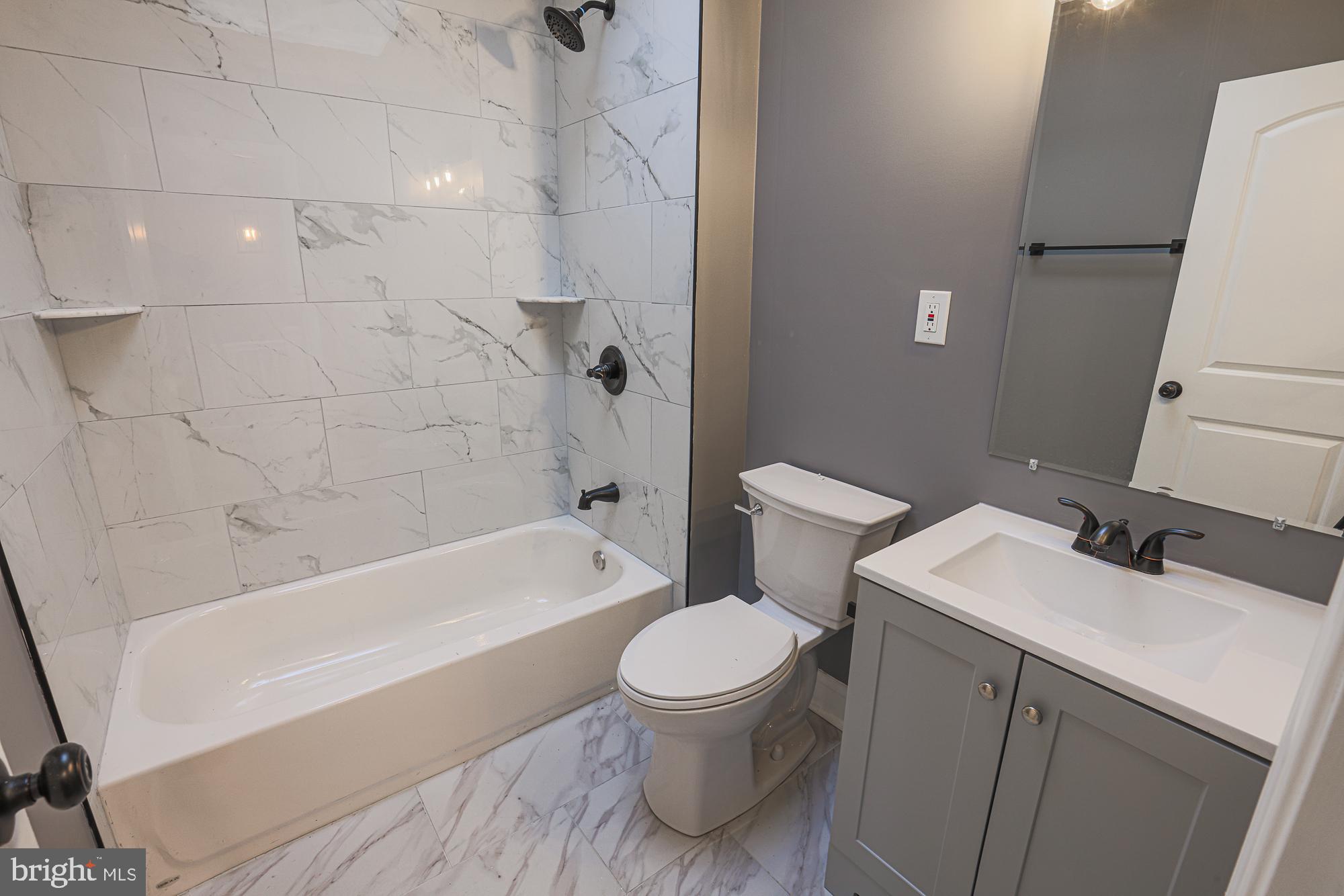 3611 Belair Road Baltimore, MD 21213 - Photo 47 of 60 a bathroom with a sink a toilet and a bathtub