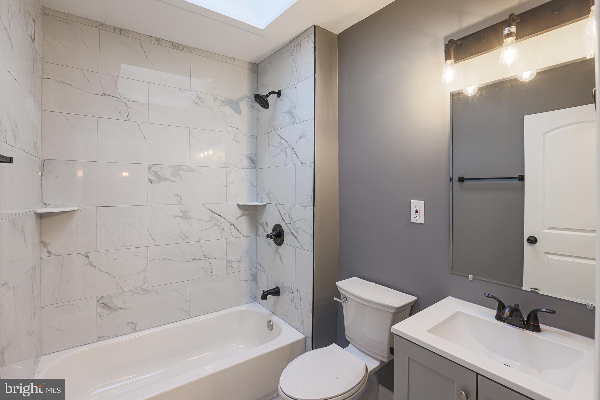 3611 Belair Road Baltimore, MD 21213 - Photo 48 of 60 a bathroom with a sink toilet and shower