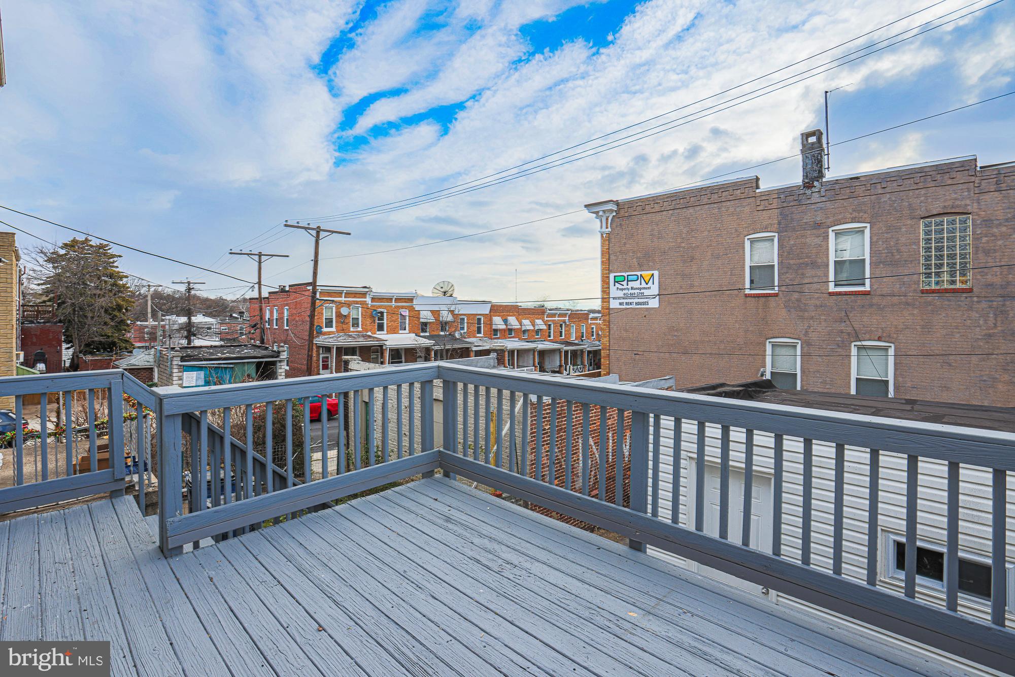 3611 Belair Road Baltimore, MD 21213 - Photo 5 of 60 a balcony with wooden floor