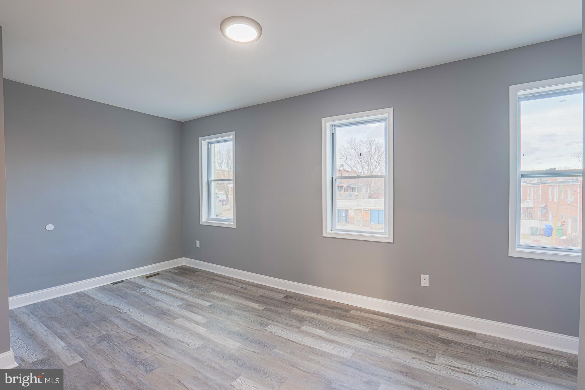 3611 Belair Road Baltimore, MD 21213 - Photo 51 of 60 a view of an empty room with wooden floor and a window