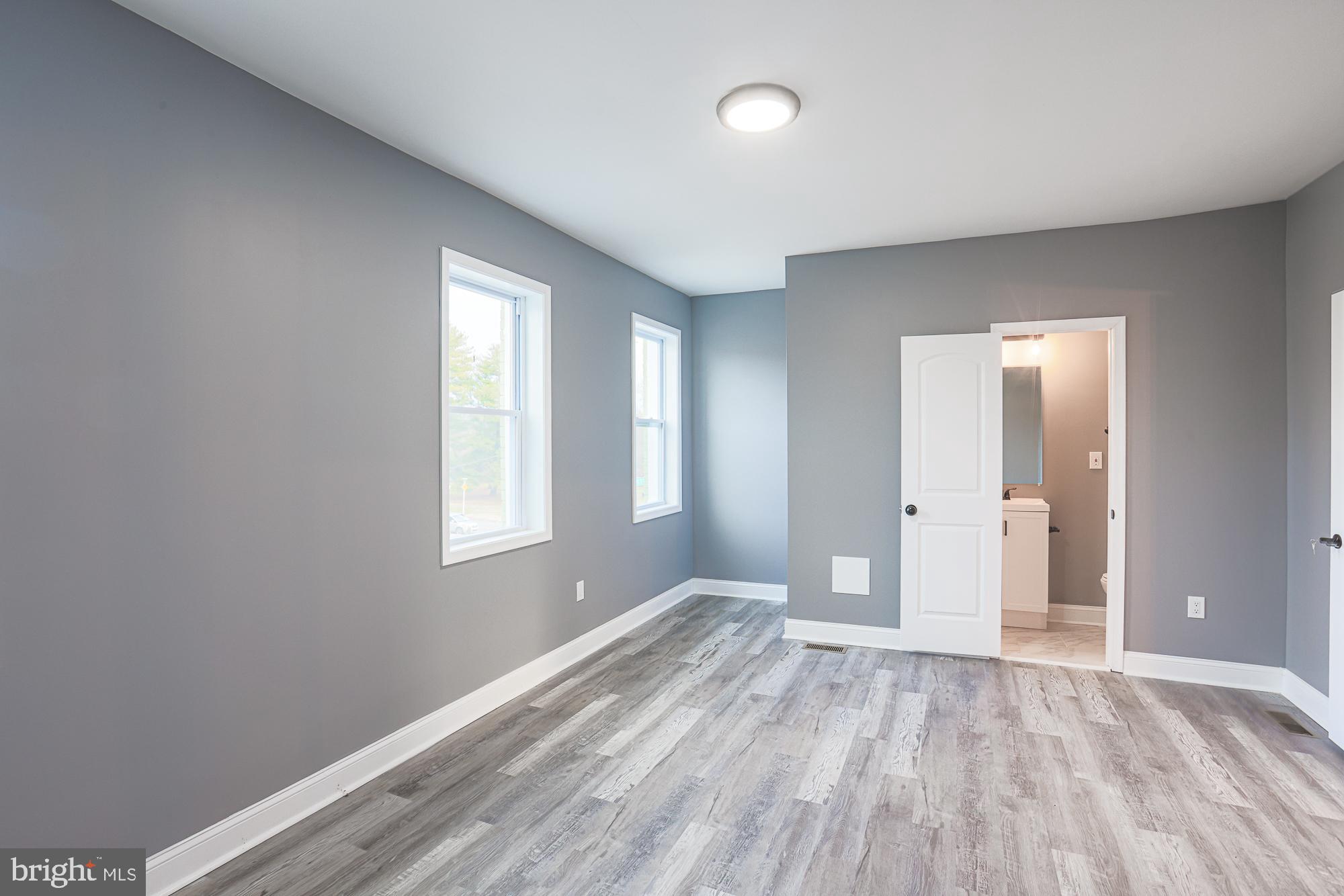 3611 Belair Road Baltimore, MD 21213 - Photo 52 of 60 a view of wooden floor and windows in a room