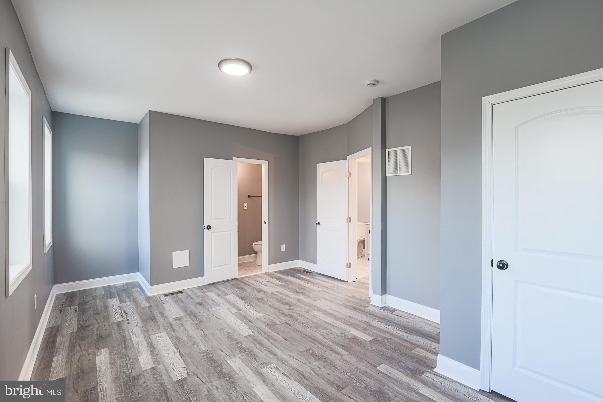 3611 Belair Road Baltimore, MD 21213 - Photo 53 of 60 a view of room with window and wooden floor