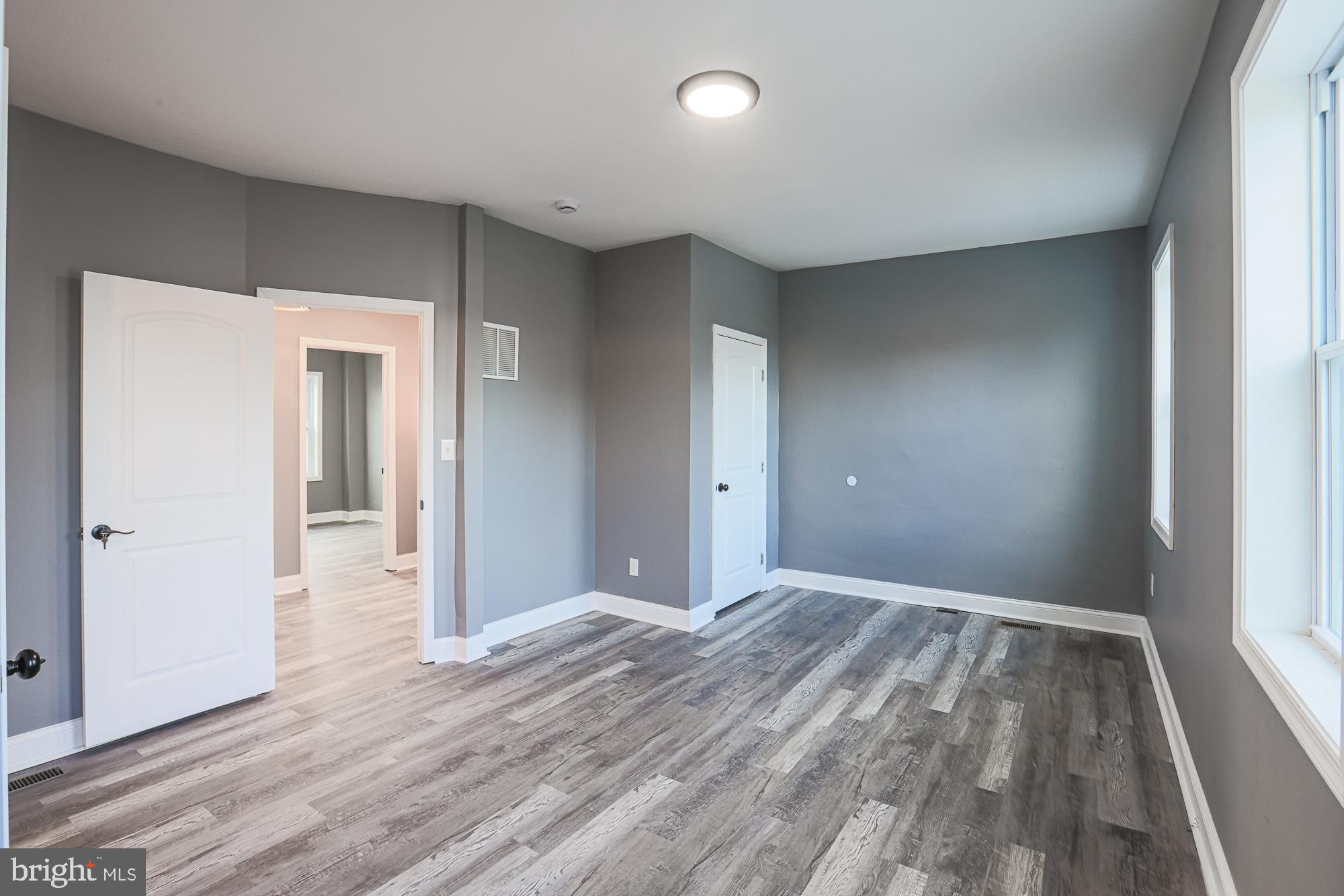 3611 Belair Road Baltimore, MD 21213 - Photo 54 of 60 wooden floor in an empty room with a window