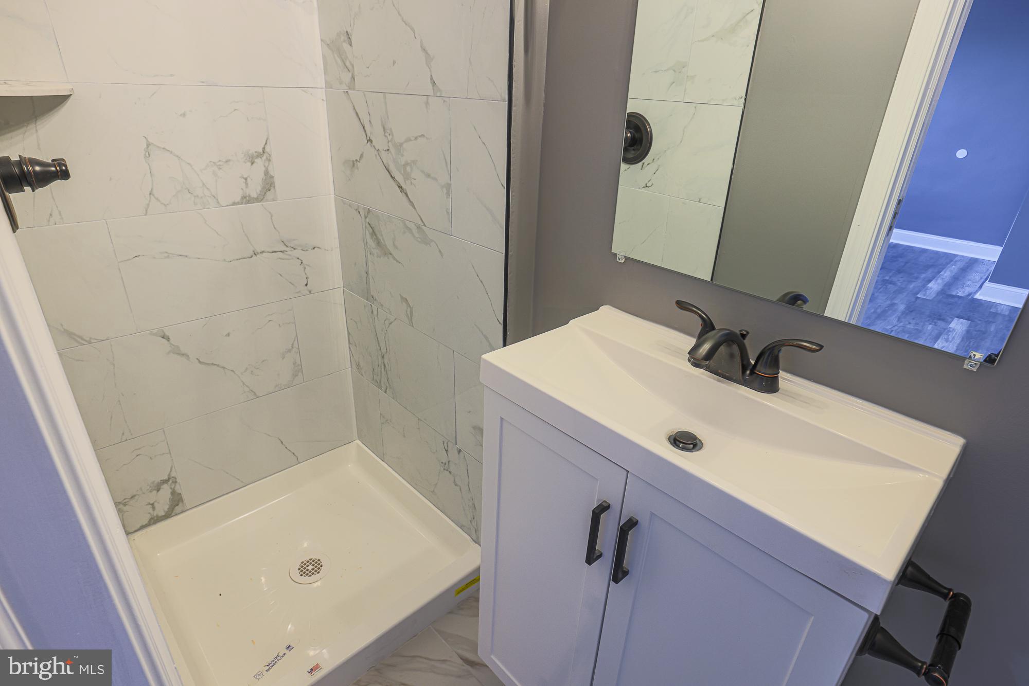 3611 Belair Road Baltimore, MD 21213 - Photo 56 of 60 a bathroom with a sink and a mirror