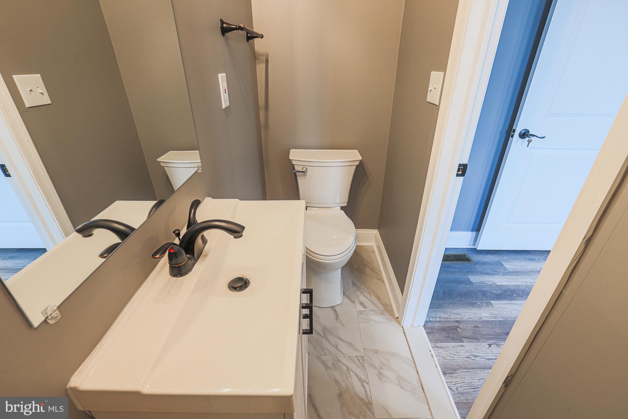 3611 Belair Road Baltimore, MD 21213 - Photo 58 of 60 a bathroom with a sink a toilet and a shower