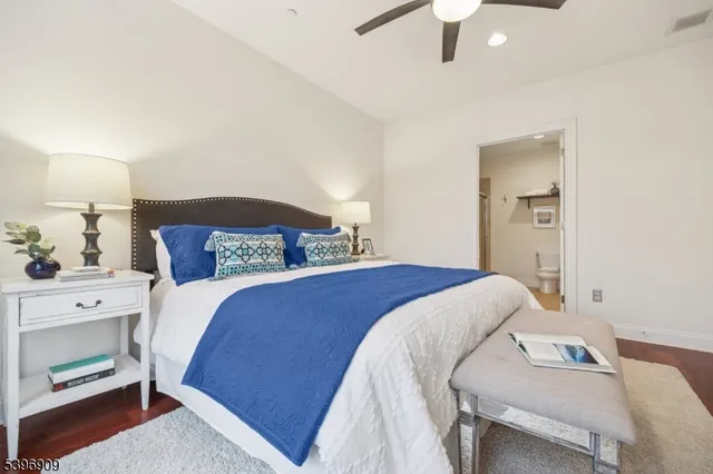 a bedroom with a bed and a lamp