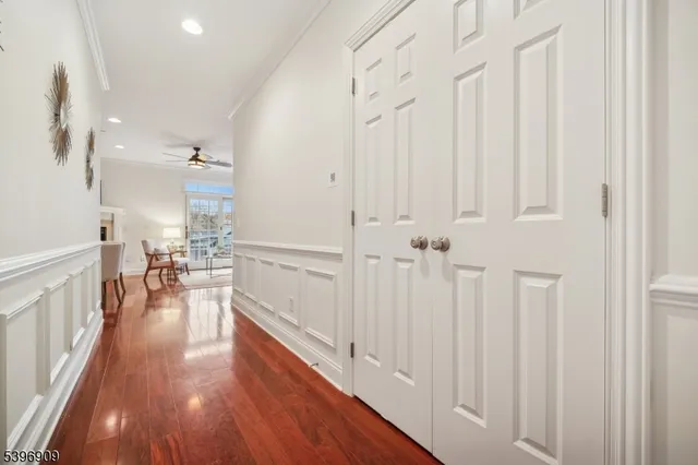 a view of a hallway with wooden floor and staircase