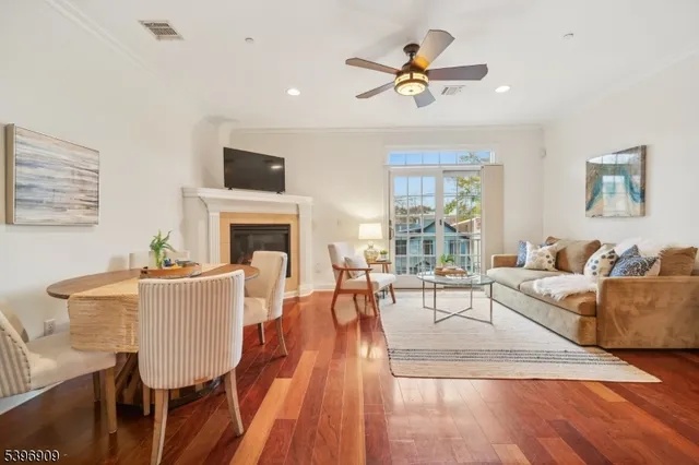 a living room with furniture fireplace and a window
