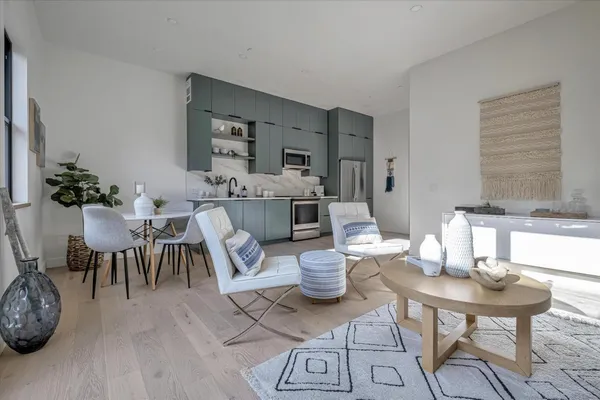 a living room with furniture a dining table and a fireplace