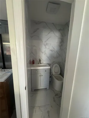 a utility room with a sink and washing machine