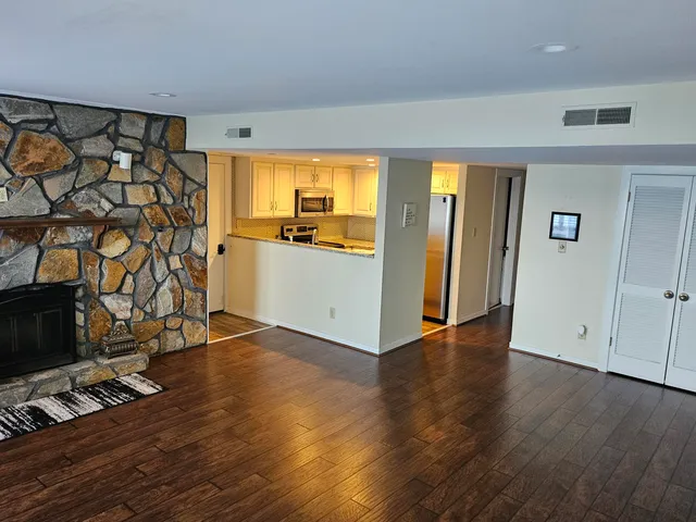 a view of a kitchen with wooden floor and a sink