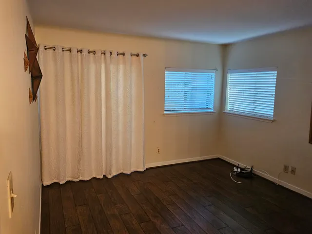a view of a closet area with wooden floor