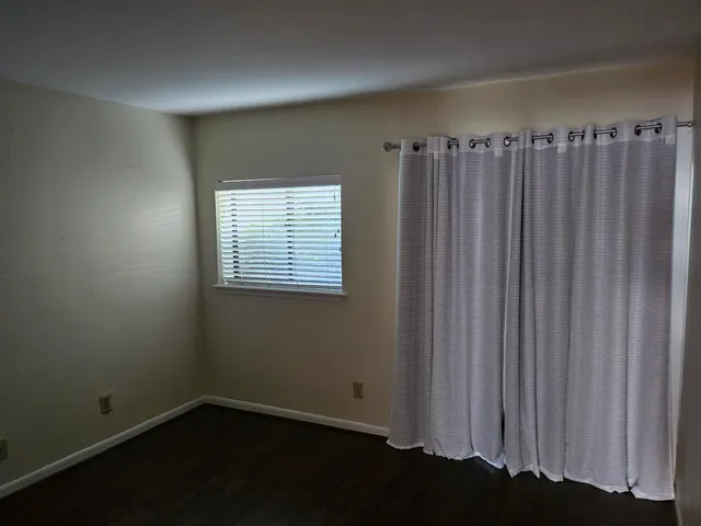 a view of a closet with wooden floor