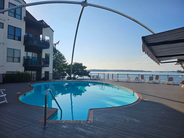 a view of a swimming pool with seating space