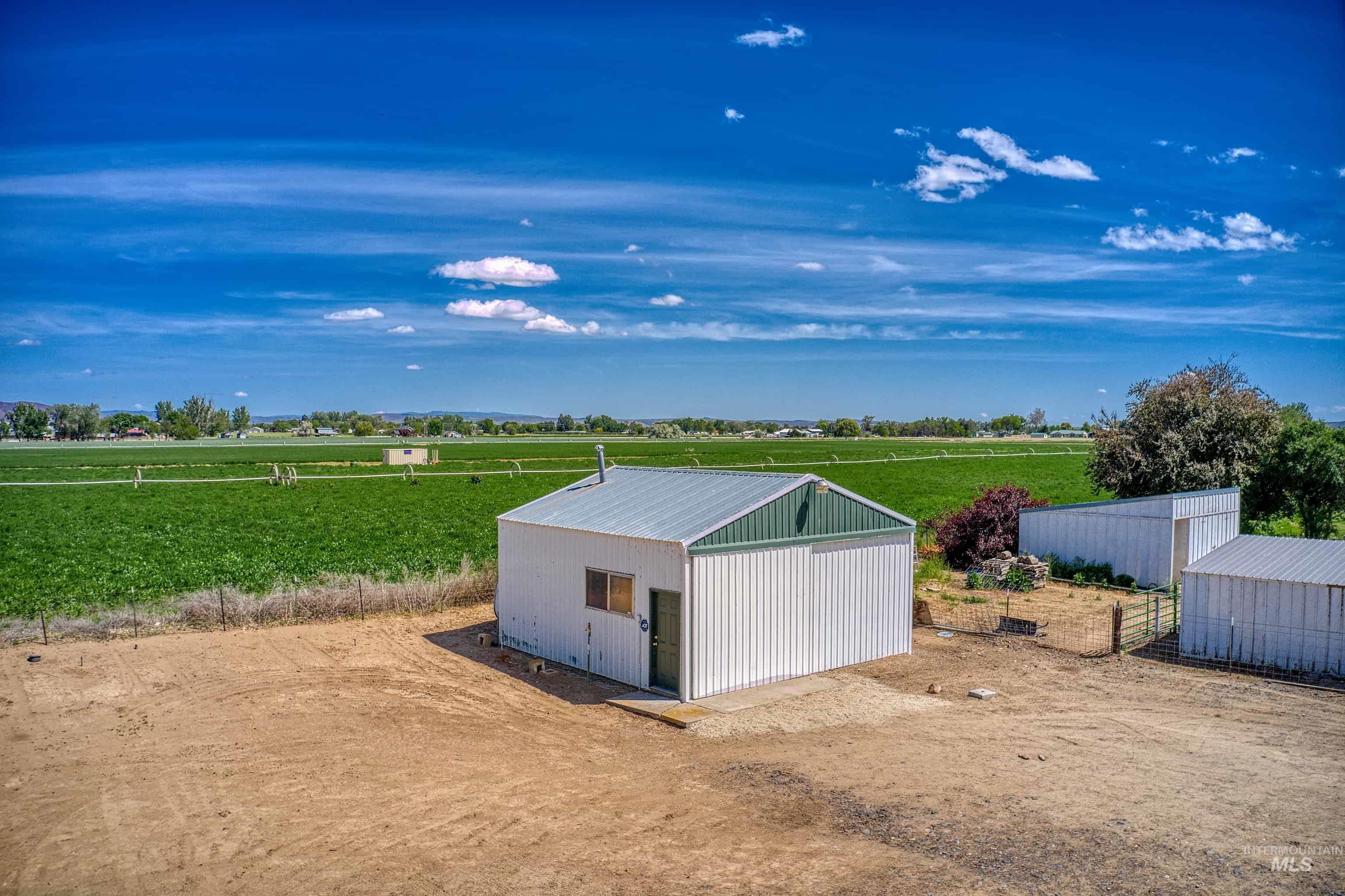 748 Pringle Road Weiser, ID 83672 - Photo 31 of 47 Metal-sided outbuilding with green trim and a metal roof, featuring a small window and a single door