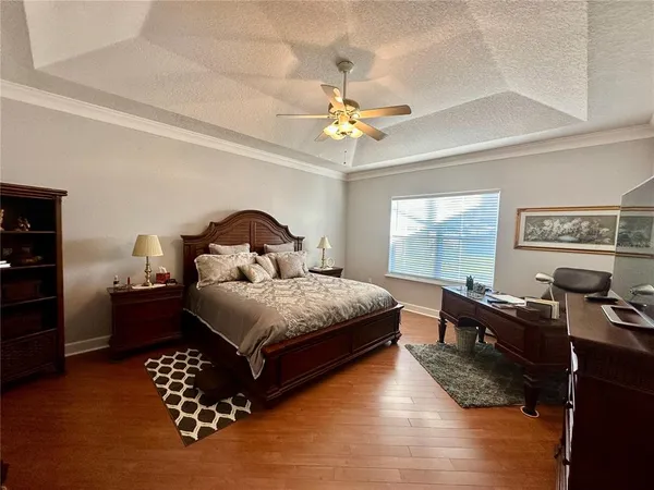 a spacious bedroom with a bed and a window