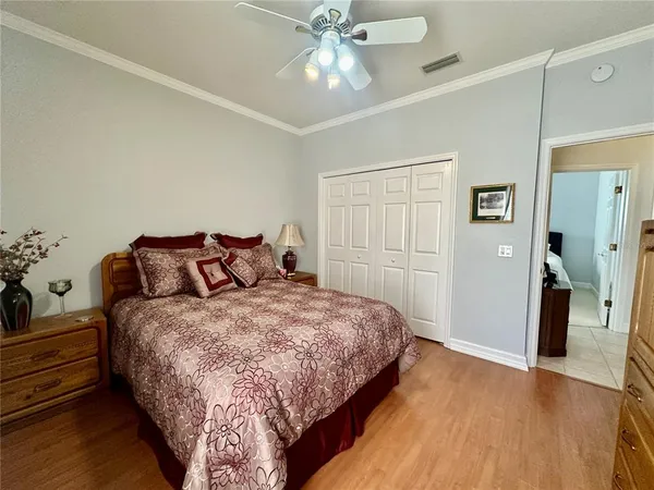 a bedroom with two beds and chair