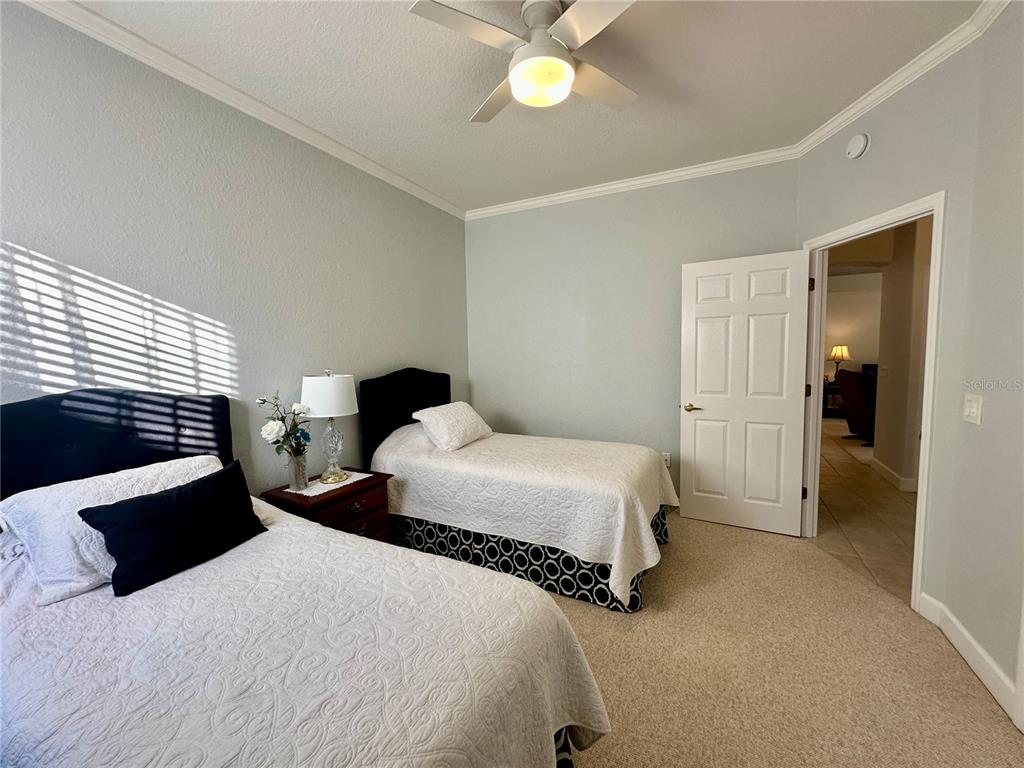 357 Ruby Lake Loop Winter Haven, FL 33884 - Photo 22 of 31 a bedroom with a bed and a chandelier