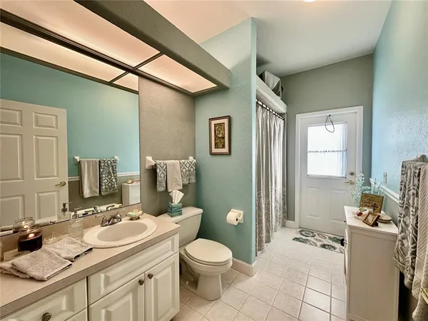 a room with a washing machine and cabinets