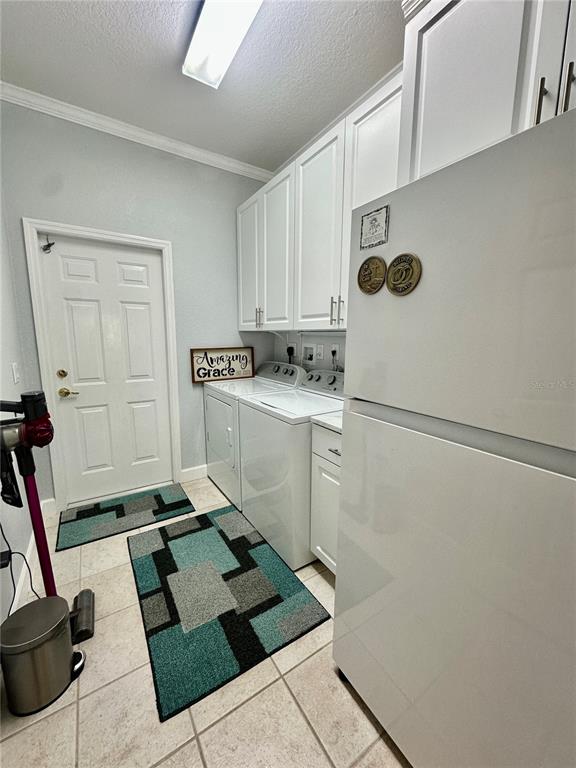 357 Ruby Lake Loop Winter Haven, FL 33884 - Photo 25 of 31 a room with a washing machine and cabinets