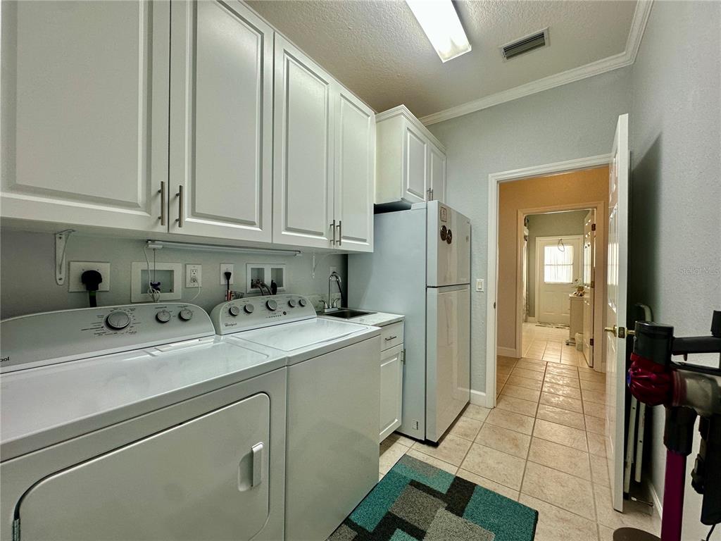 357 Ruby Lake Loop Winter Haven, FL 33884 - Photo 26 of 31 a view of a storage & utility room with a sink
