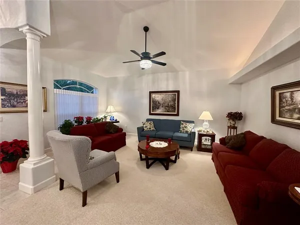 a living room with furniture a rug and a window