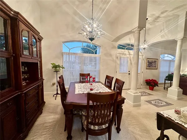 a view of a dining room with furniture and chandelier