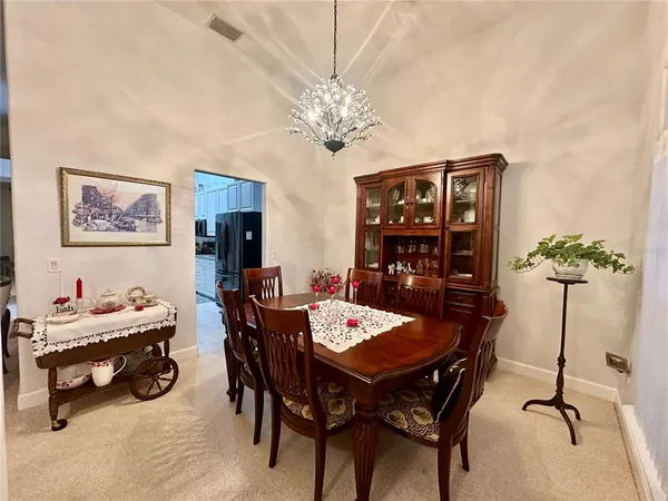 a view of a dining room with furniture and chandelier
