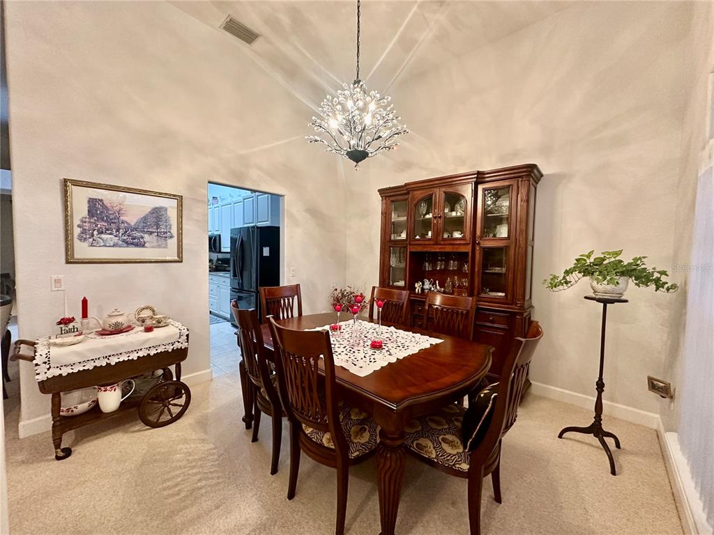 357 Ruby Lake Loop Winter Haven, FL 33884 - Photo 6 of 31 a view of a dining room with furniture and chandelier